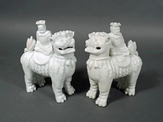 Rare Pair of Blanc de Chine Figures of Foreigners Riding upon Fu Lions