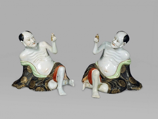 Unusual Pair of Chinese Porcelain Figures of Reclining Lohans